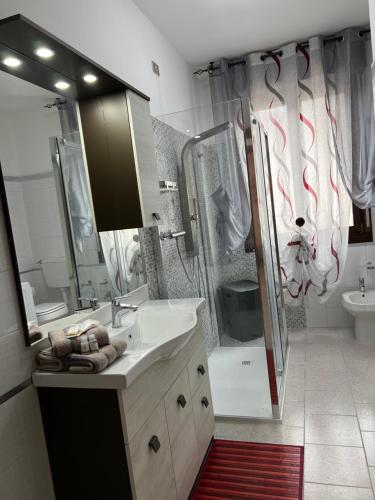 a bathroom with a sink and a shower at Civico 13 in Scardovari