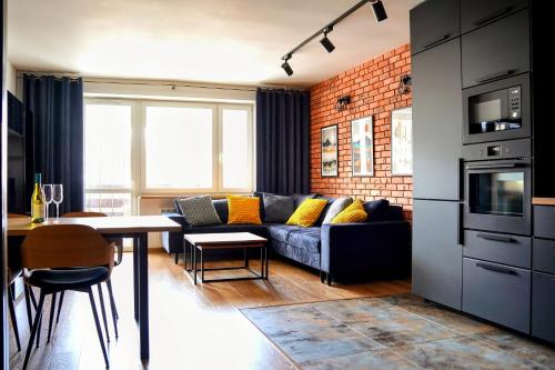 a living room with a couch and a table at Apartament 914 in Wisła
