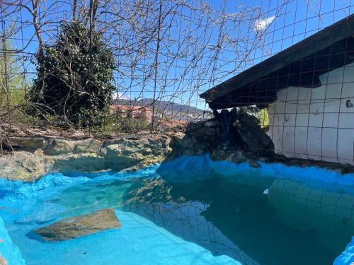 a pool of blue water next to a building at Casa Fidelina I Miraflores de la Sierra in Madrid
