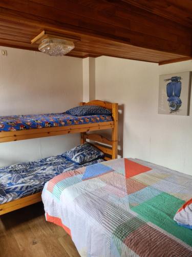 a bedroom with two bunk beds and a bed at commealaferme71.vacances in Montret
