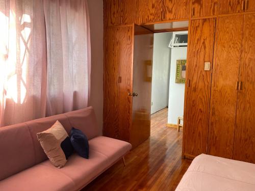 a living room with a couch with two pillows on it at Casa centríca accesible a los lugares más turísticos in Mexico City