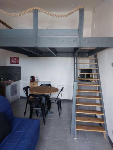 Cette chambre dispose d'un escalier et d'une table avec des chaises. dans l'établissement Studio 4 personnes, à Montagne