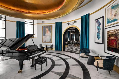 a piano in a room with a gold ceiling at Grand Bohemian Hotel Orlando, Autograph Collection in Orlando