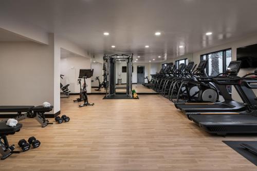 a gym with a row of treadmills and machines at Grand Bohemian Hotel Orlando, Autograph Collection in Orlando