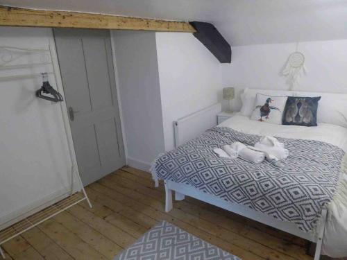 a bedroom with a bed with two dogs on it at Quirky Cottage in the Heart of Appleby in Appleby