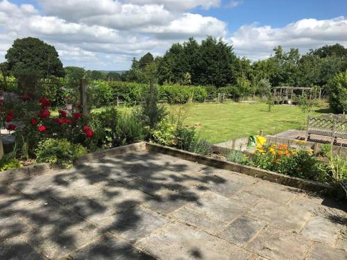 a garden with a view of a park at Oak Frame Barn Studio in Rural AONB Chiddingfold in Chiddingfold