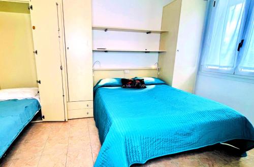 a bedroom with a blue bed with a purse on it at Residence Frontemare in Rimini