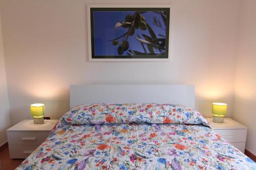 a bedroom with a bed and two night stands with lamps at Villa Giulia - Cilento - Giungano in Giungano