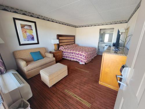 a hotel room with a bed and a couch at Studio 9 Inn & Suites in Decatur