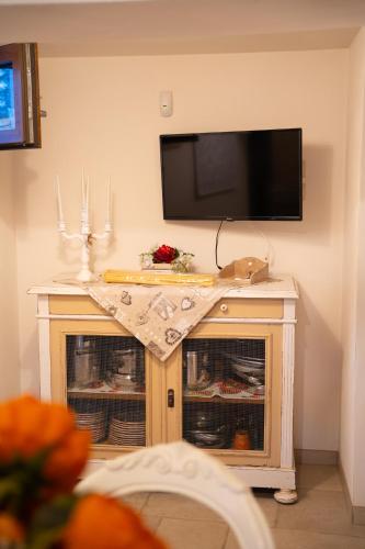a living room with a tv on a wall at Trulli Magnolia in Putignano