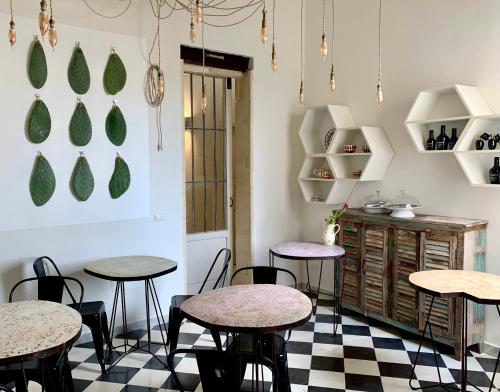 a room with tables and chairs on a checkered floor at HABITARE Lecce & Salento in Lecce