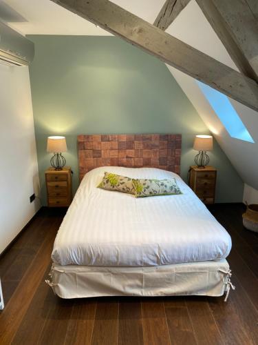 a bedroom with a large bed and two lamps at La Mezzanine des Rohan Saverne in Saverne