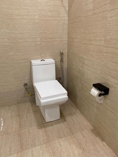a bathroom with a toilet and a roll of toilet paper at Mystic Vibes - Jibhi in Jibhi