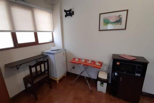 a kitchen with a small refrigerator and a table in a room at Monoambiente en zona central norte in Cochabamba