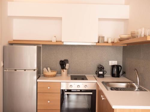 a kitchen with a stainless steel refrigerator and a sink at STARI in Kattavía