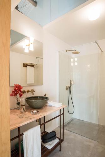 a bathroom with a sink and a shower at Green&Houses in Ponta Delgada