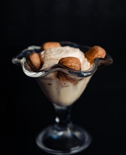 a glass bowl filled with ice cream and peanuts at Casa Del Sole in Alba Iulia