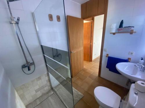 a bathroom with a shower and a toilet and a sink at Chalet Sa Rapita in Sa Ràpita