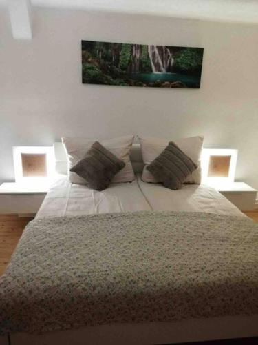 a bedroom with a large bed with two pillows at Appartement für bis zu 8 Personen in Amstetten in Amstetten