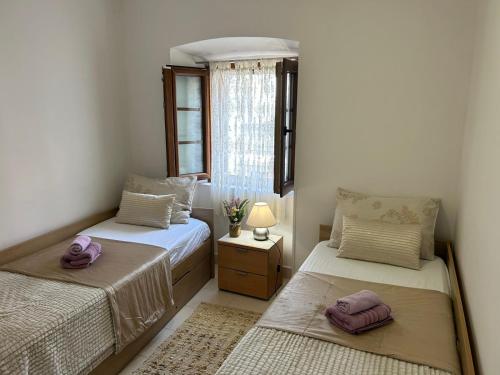a bedroom with two beds and a window at Apartment Marko in Kotor