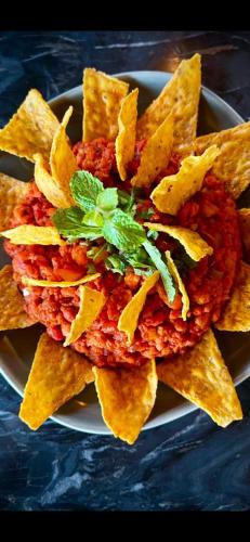 a plate of food with meat and chips at Empyrean Dhaka City Centre in Dhaka