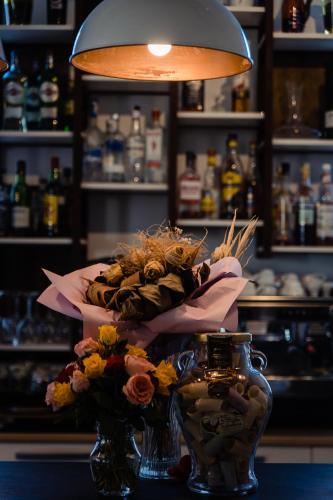 a bouquet of flowers in a vase on a table at Casa Del Sole in Alba Iulia