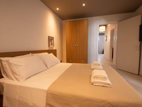 a bedroom with a large bed with towels on it at STARI in Kattavía