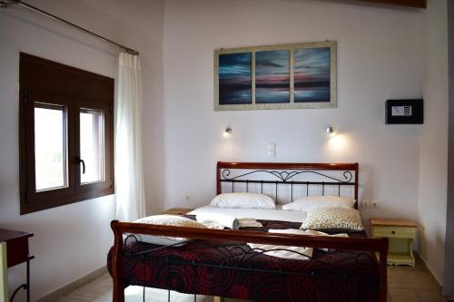 a bedroom with a bed in a room with a window at Marinakis Sea View Studios in Sougia
