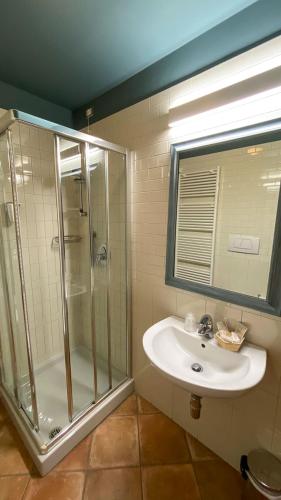 a bathroom with a glass shower and a sink at Hotel La Fattoria in Spoleto