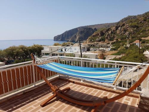 a hammock on a balcony with a view of the ocean at Marinakis Sea View Studios in Sougia