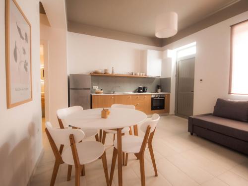 a kitchen and a table and chairs in a room at STARI in Kattavía