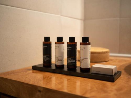 three bottles of hair products sitting on a table at STARI in Kattavía
