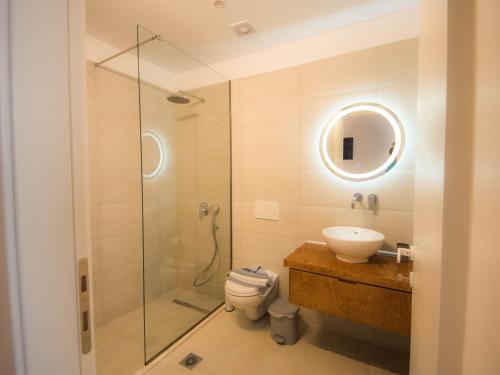 a bathroom with a shower and a toilet and a sink at STARI in Kattavía