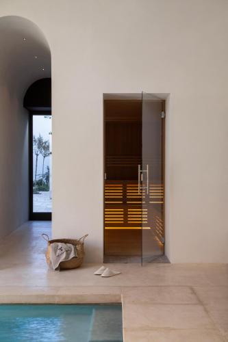 a room with a swimming pool next to a building at Palazzo Tafuri Boutique Hotel in Nardò