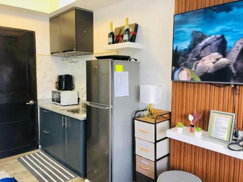 a kitchen with a stainless steel refrigerator in a room at Spacious Combine Family Unit Condo at Mesaverte Residences downtown near SM Gaisano Robinson and Centrio in Cagayan de Oro