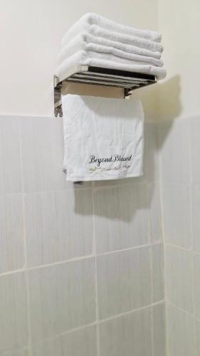 a group of white towels on a rack in a bathroom at Spacious Combine Family Unit Condo at Mesaverte Residences downtown near SM Gaisano Robinson and Centrio in Cagayan de Oro