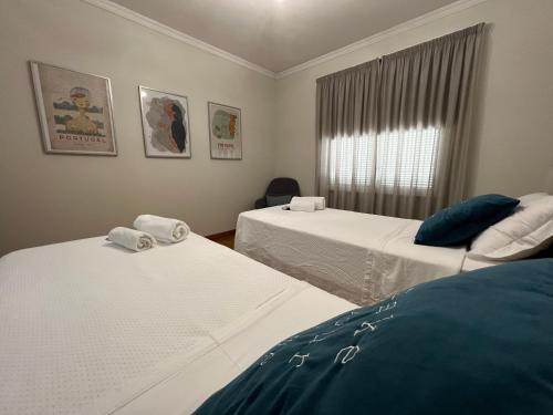 a room with two beds and a window at Dona I House - In Funchal with free parking in Funchal