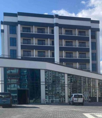 a large building with a white van parked in front of it at Ankara Yenimahalle'de temiz ve konforlu özel oda in Yenimahalle