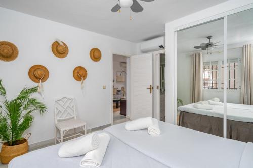 a bedroom with two beds and a mirror at La Duquesa apartment with pool Ref M8 in Manilva