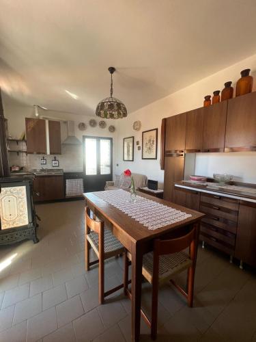 a kitchen with a wooden table and a dining room at Gloria's house in Zerbolò