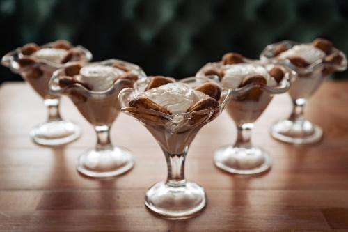 a group of wine glasses filled with ice cream at Casa Del Sole in Alba Iulia