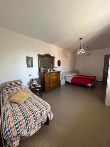 a bedroom with two beds and a dresser at Gloria's house in Zerbolò