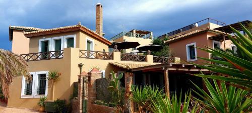 a large house with a balcony on top of it at Vrachokipos in Souvala