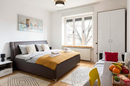 een witte slaapkamer met een bed en een raam bij Cibona Station Apartments in Zagreb
