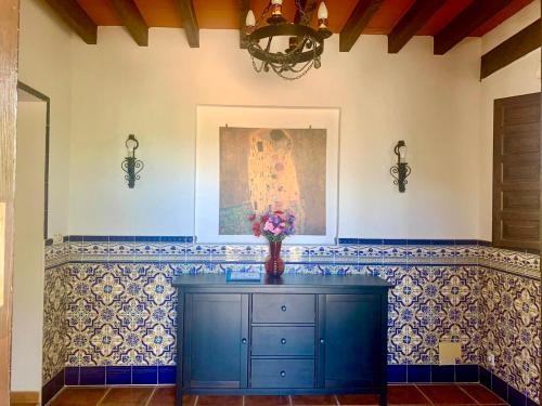 a room with a blue cabinet with a vase of flowers at Private villa large pool elevated quiet secluded location, near Mojacar in Antas