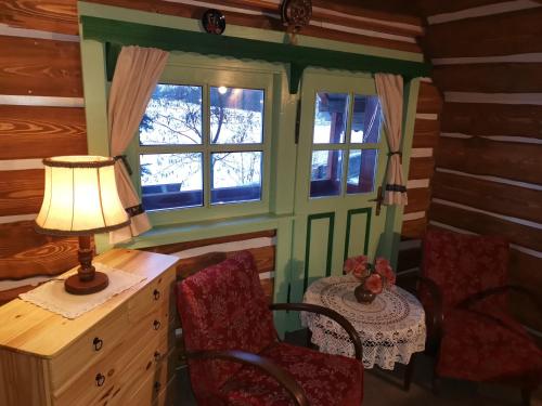 a room with a desk and a table with a lamp at Chalupa Peter in Liptovský Michal