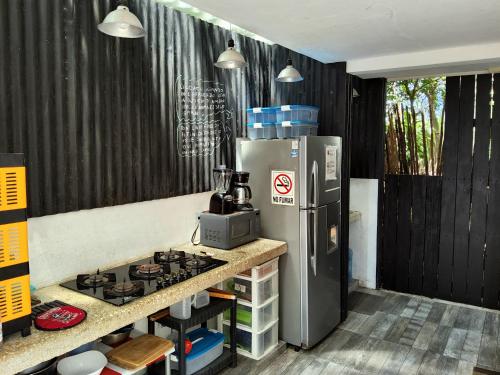 a kitchen with a stove and a refrigerator at TR3S by Walter de la Renta in Cancún