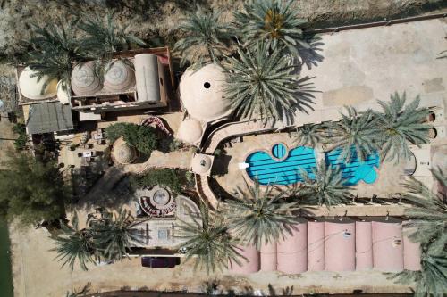 an aerial view of a resort with palm trees at Panta Lodge Siwa بنتا لودج سيوة in Siwa