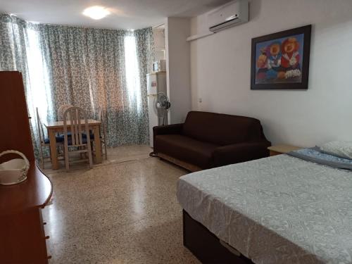 - une chambre avec un lit, un canapé et une table dans l'établissement ESTUDIO EDIFICIO LIMA-TORREMOLINOS, à Torremolinos