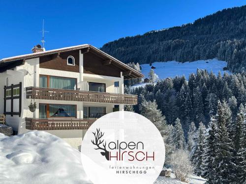 a building with a sign that reads golden hski at alpenHIRSCH - Ferienwohnungen in Hirschegg